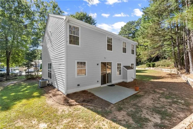 a view of a house with yard and a tree