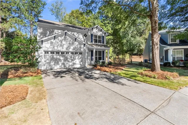a view of a house with a yard and pathway