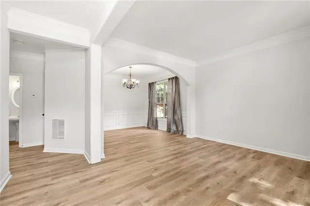 a view of an empty room and wooden floor