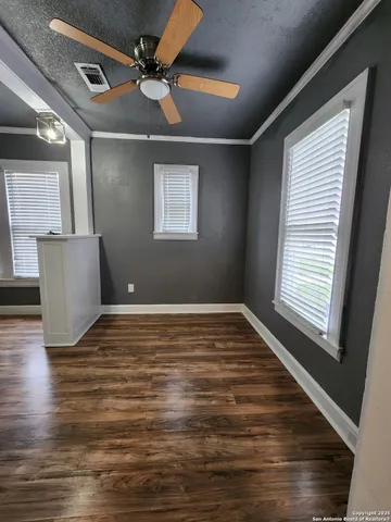 a view of a livingroom with a ceiling fan and window