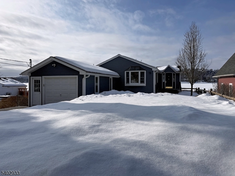 96 East Shore Trail Sparta, NJ 07871 - Photo 1 of 44 a front view of a house with a yard covered in snow