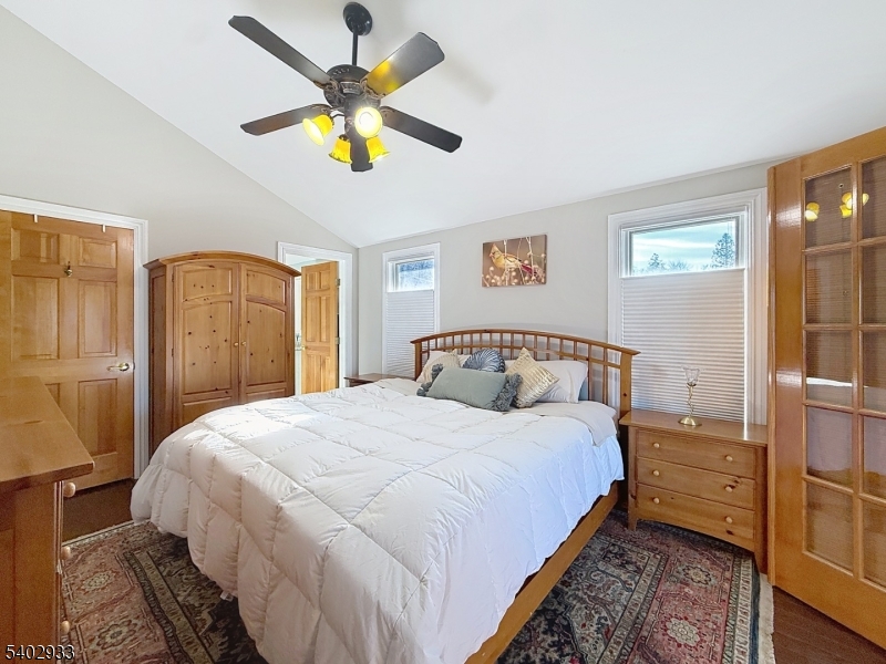 96 East Shore Trail Sparta, NJ 07871 - Photo 18 of 44 a bedroom with a bed and a chandelier