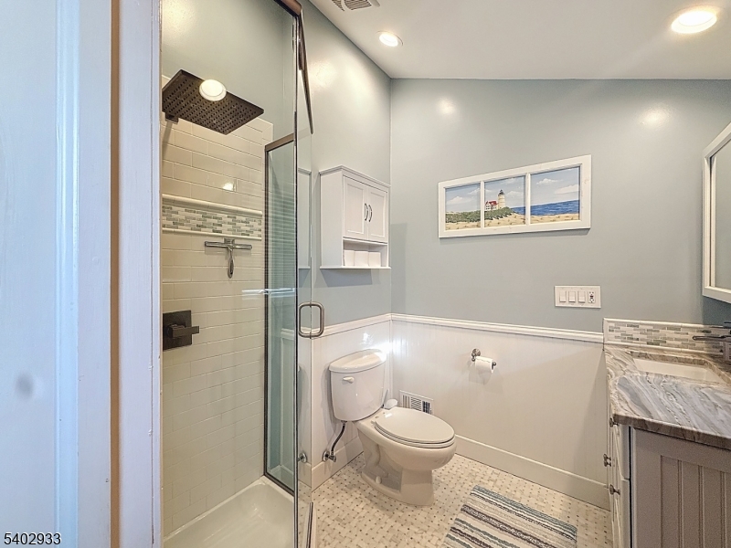 96 East Shore Trail Sparta, NJ 07871 - Photo 19 of 44 a bathroom with a sink a toilet and shower