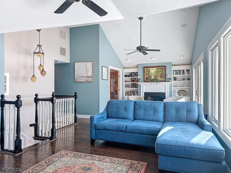 96 East Shore Trail Sparta, NJ 07871 - Photo 9 of 44 a living room with furniture and a chandelier