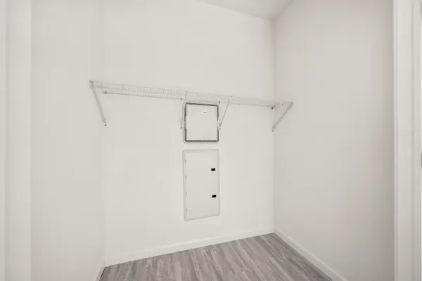 a front view of a building with a garden and entryway