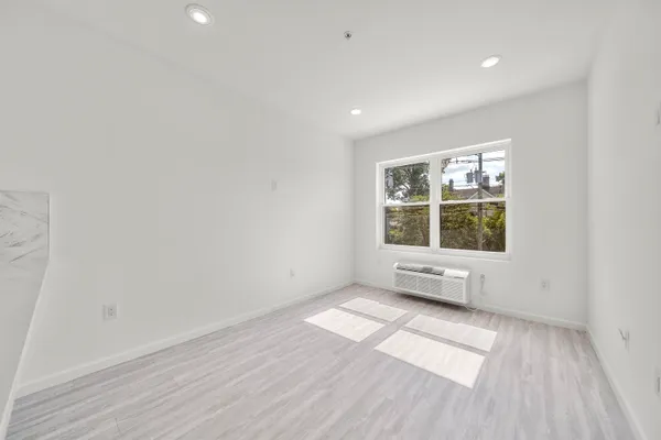 a kitchen with stainless steel appliances and wooden floor