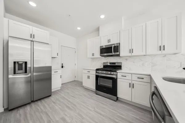 a large room with a glass door shower
