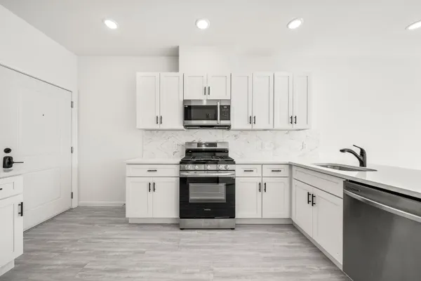 a view of a hallway with closet and wooden floor