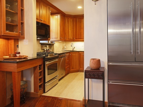 34 Garrison Road, Unit 2 Brookline, MA 02445 - Photo 3 of 7 a kitchen with stainless steel appliances granite countertop a refrigerator a stove a sink and a microwave