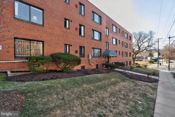 a view of a brick building next to a yard
