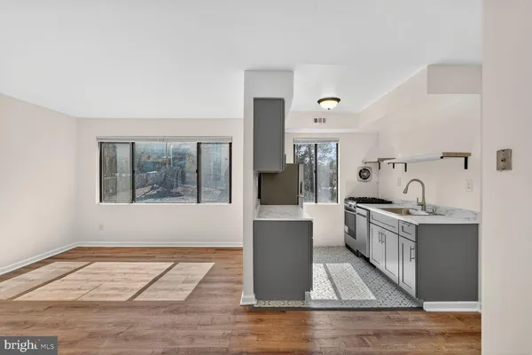 a kitchen with stainless steel appliances granite countertop a stove and a sink