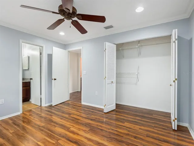 a view of empty room with wooden floor