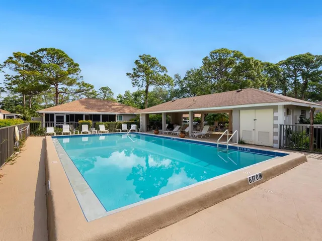 swimming pool view with a seating space and a garden view