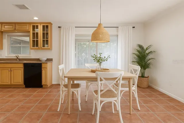 a view of a dining room with furniture and a chandelier