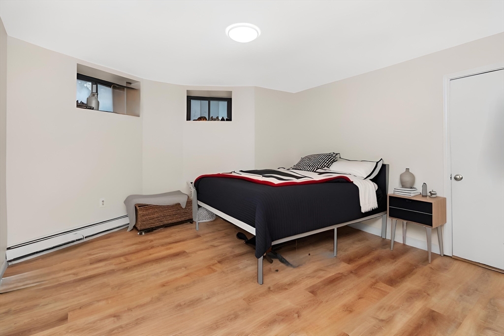 8 Colliston Road Boston, MA 02135 - Photo 26 of 40 a bedroom with a bed and a table in it
