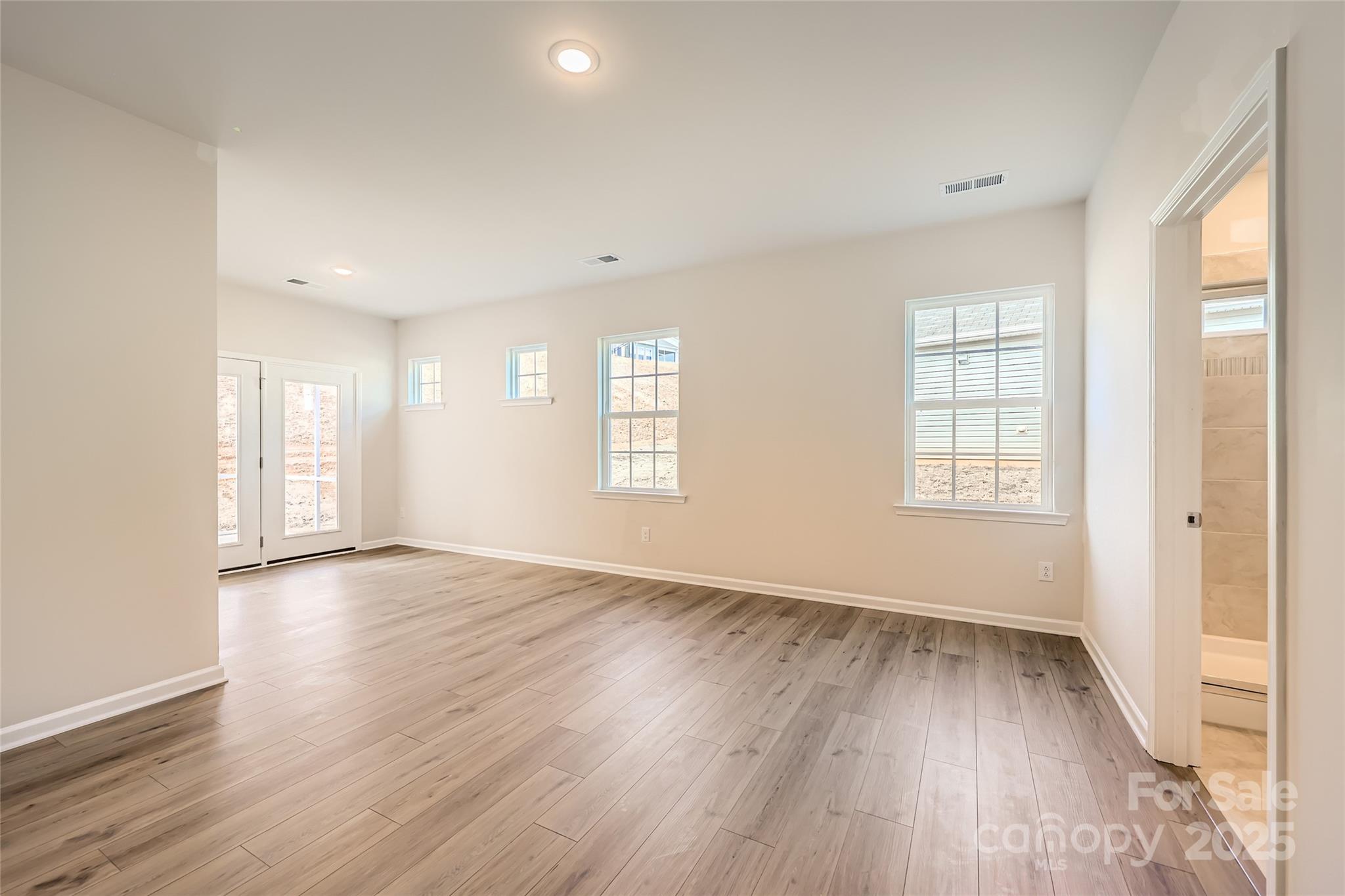 5932 Oak Br Circle Maiden, NC 28650 - Photo 7 of 13 an empty room with wooden floor and windows