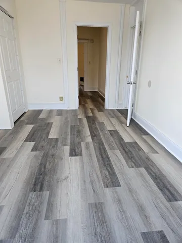 a view of a room with wooden floor