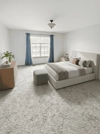 a spacious bedroom with a bed and a window