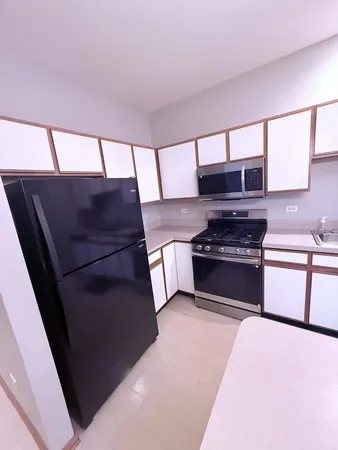 a kitchen with a stove and a refrigerator