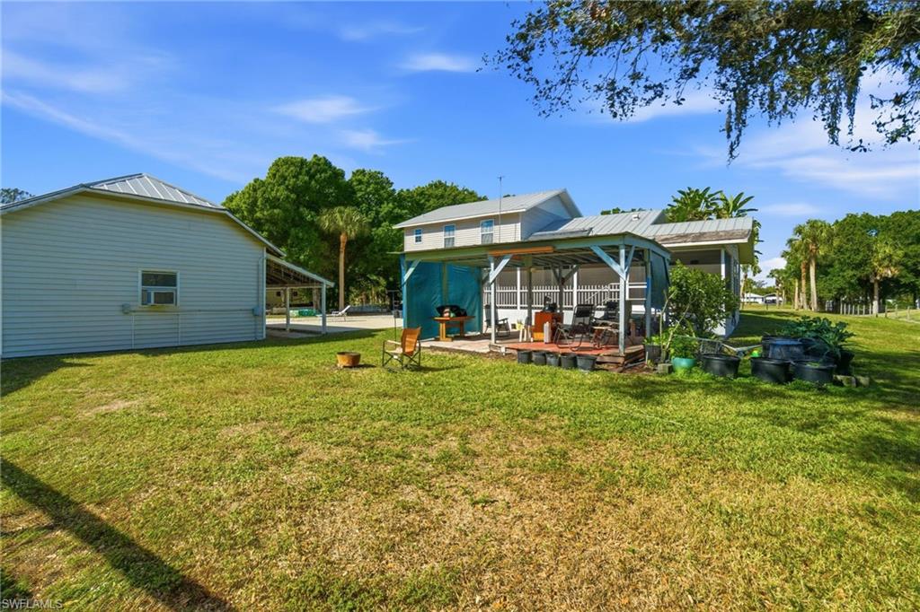 5860 Dogwood Way Naples, FL 34116 - Photo 11 of 36 a view of a house with a yard patio and fire pit