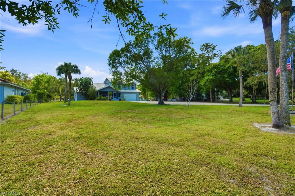 5860 Dogwood Way Naples, FL 34116 - Photo 13 of 36 a view of a big yard with a house