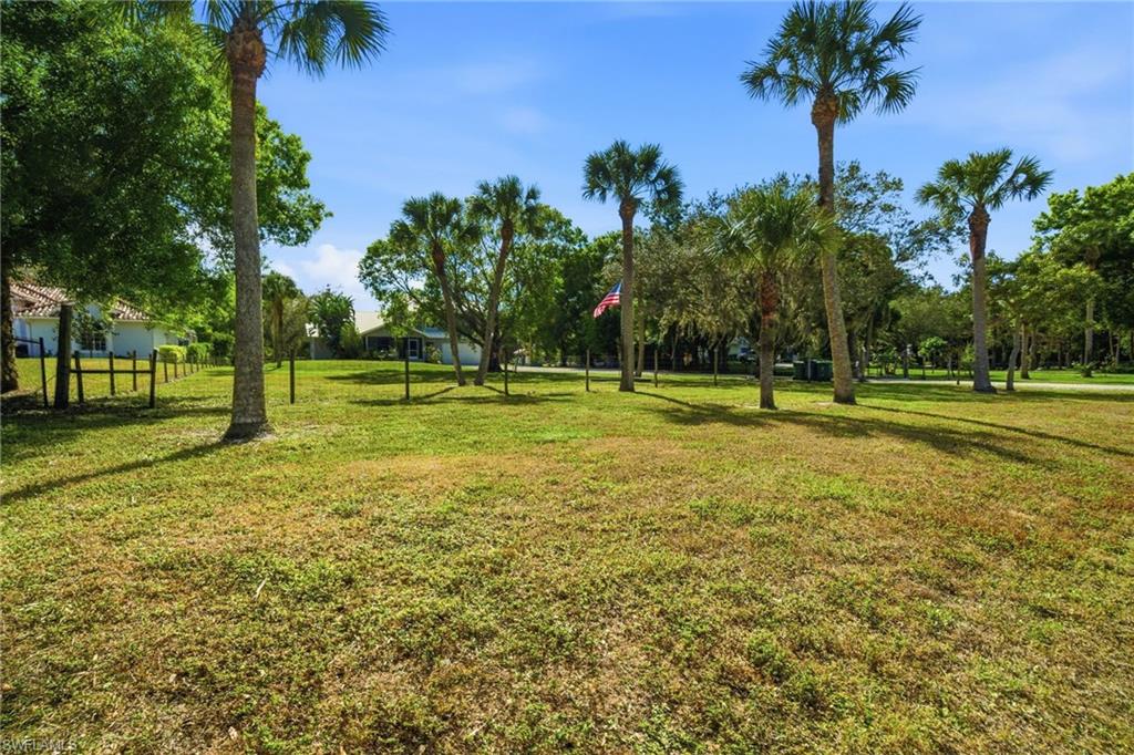 5860 Dogwood Way Naples, FL 34116 - Photo 14 of 36 a view of a golf course with a lake