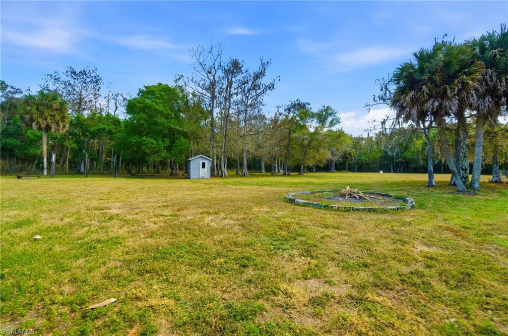 5860 Dogwood Way Naples, FL 34116 - Photo 17 of 36 a view of a swimming pool with a yard