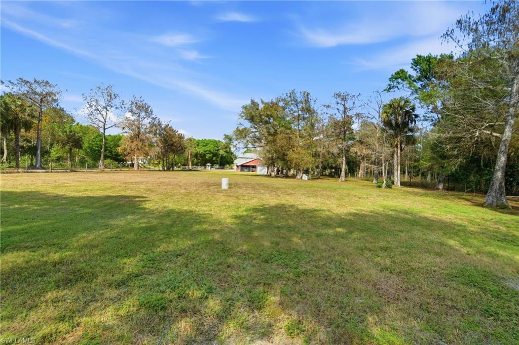 5860 Dogwood Way Naples, FL 34116 - Photo 20 of 36 a view of grassy field with trees