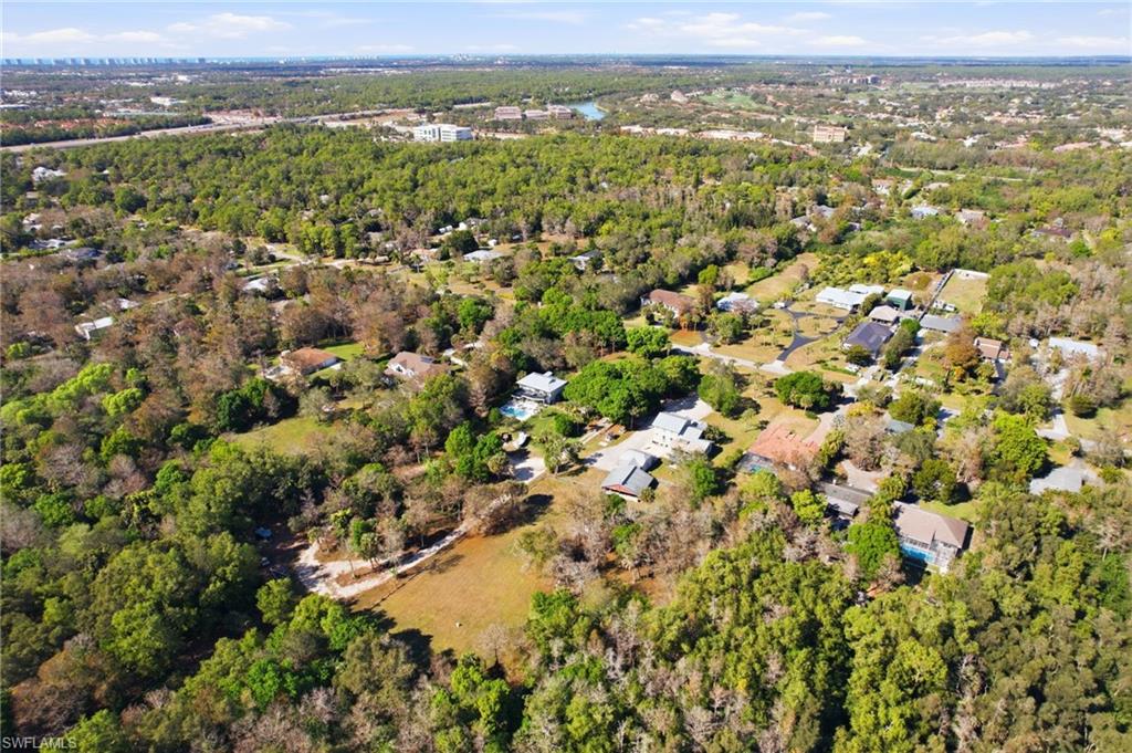 5860 Dogwood Way Naples, FL 34116 - Photo 33 of 36 an aerial view of residential houses with outdoor space and trees