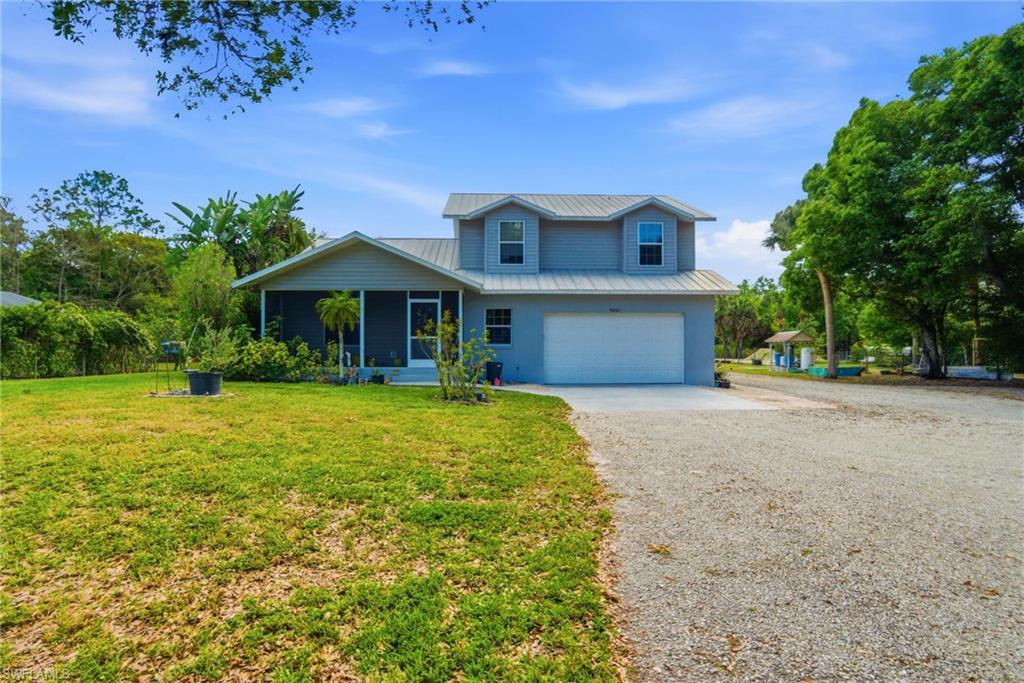 5860 Dogwood Way Naples, FL 34116 - Photo 5 of 36 a front view of a house with a yard