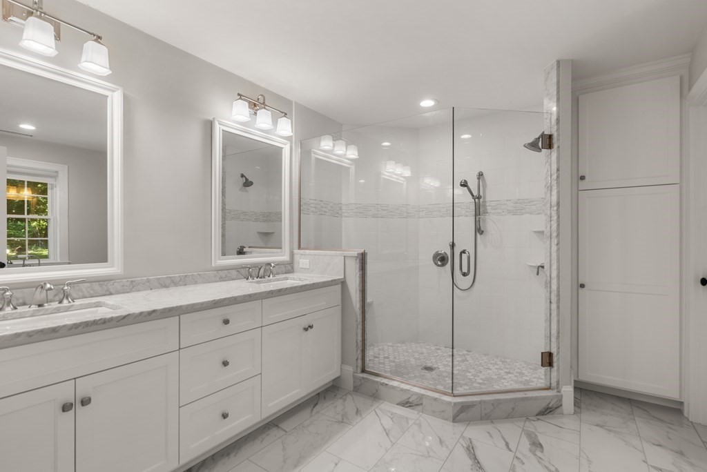 22 Dunedin Road Wellesley, MA 02481 - Photo 12 of 16 a bathroom with a shower sink and mirror