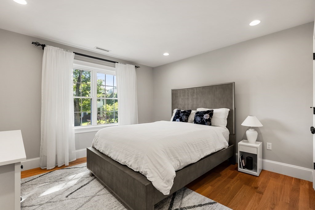 22 Dunedin Road Wellesley, MA 02481 - Photo 13 of 16 a large bedroom with a bed and wooden floor