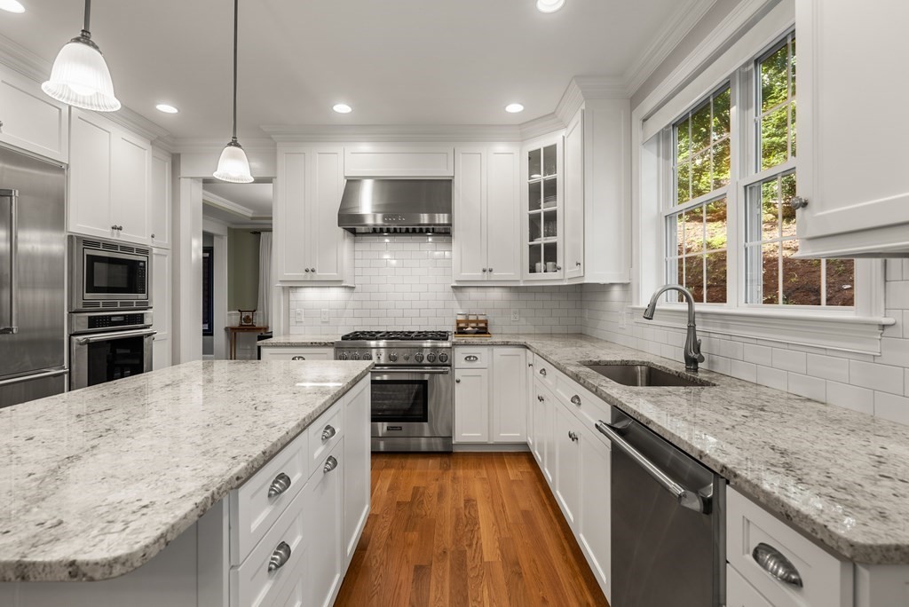 22 Dunedin Road Wellesley, MA 02481 - Photo 5 of 16 a large kitchen with stainless steel appliances granite countertop a stove and a sink