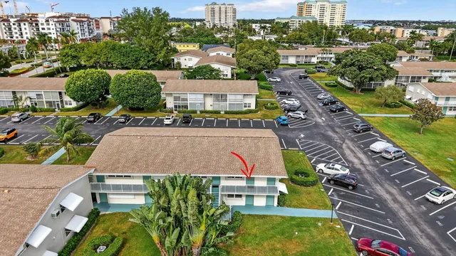 an aerial view of a house with a yard and outdoor seating