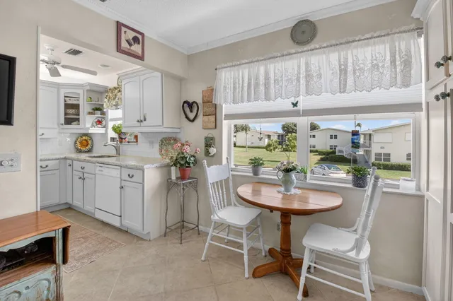 a kitchen with a sink cabinets and window