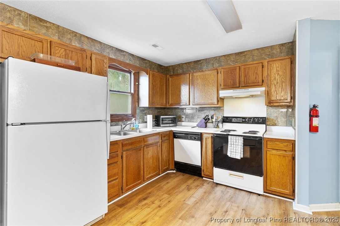1132 Hoke Loop Road Fayetteville, NC 28314 - Photo 13 of 29 a kitchen with stainless steel appliances granite countertop a refrigerator and a stove top oven