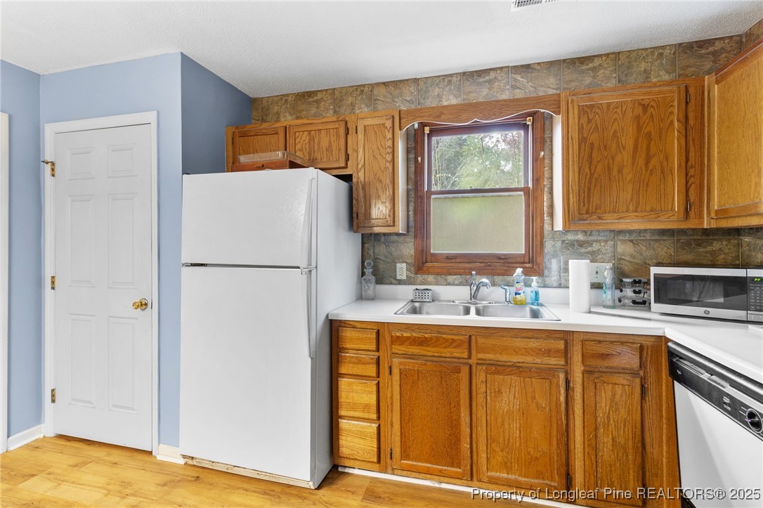 1132 Hoke Loop Road Fayetteville, NC 28314 - Photo 15 of 29 a kitchen with a refrigerator and a sink