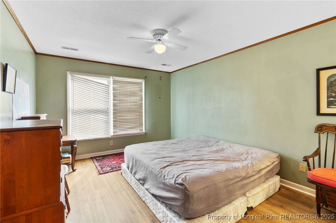 1132 Hoke Loop Road Fayetteville, NC 28314 - Photo 16 of 29 a bedroom with a bed and a table in it