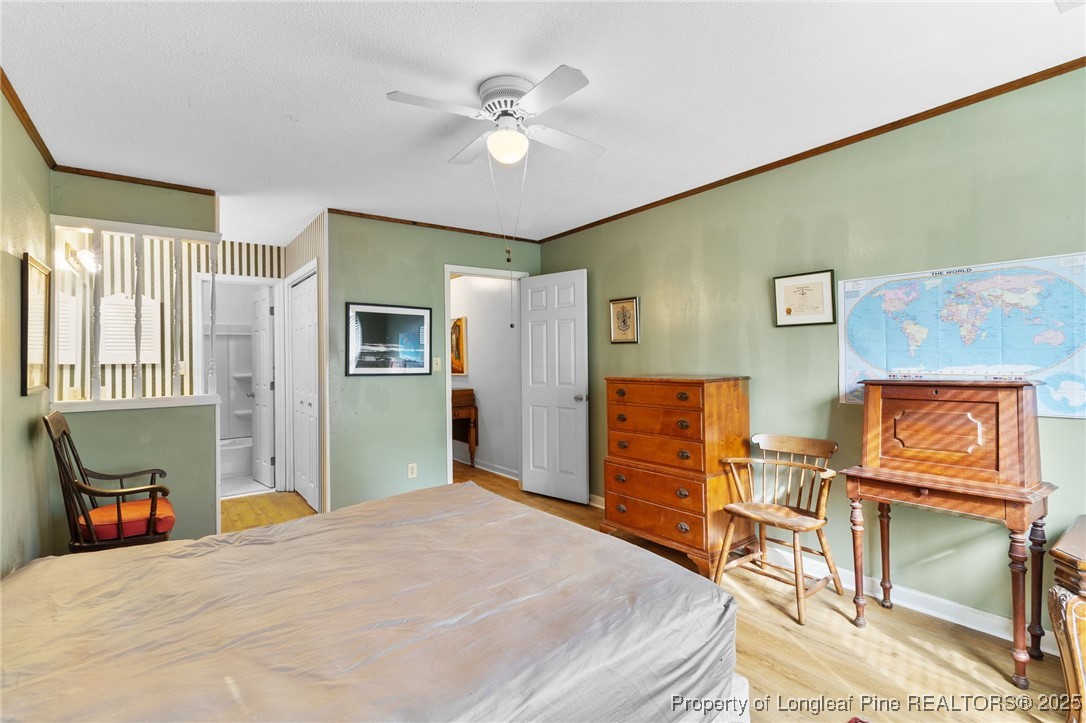 1132 Hoke Loop Road Fayetteville, NC 28314 - Photo 18 of 29 a bedroom with a bed and dresser with chair