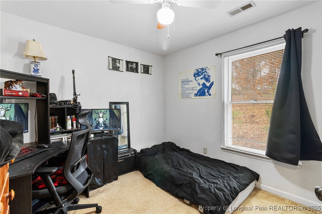 1132 Hoke Loop Road Fayetteville, NC 28314 - Photo 22 of 29 a bedroom with a bed dresser and a window