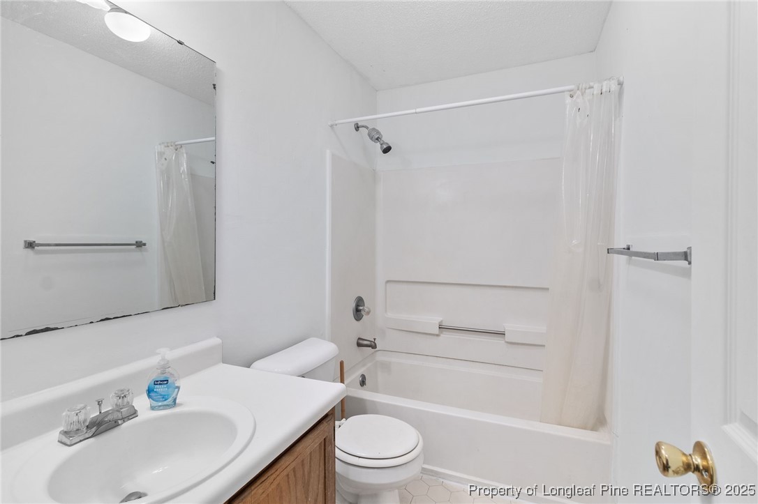 1132 Hoke Loop Road Fayetteville, NC 28314 - Photo 23 of 29 a bathroom with a sink toilet and shower