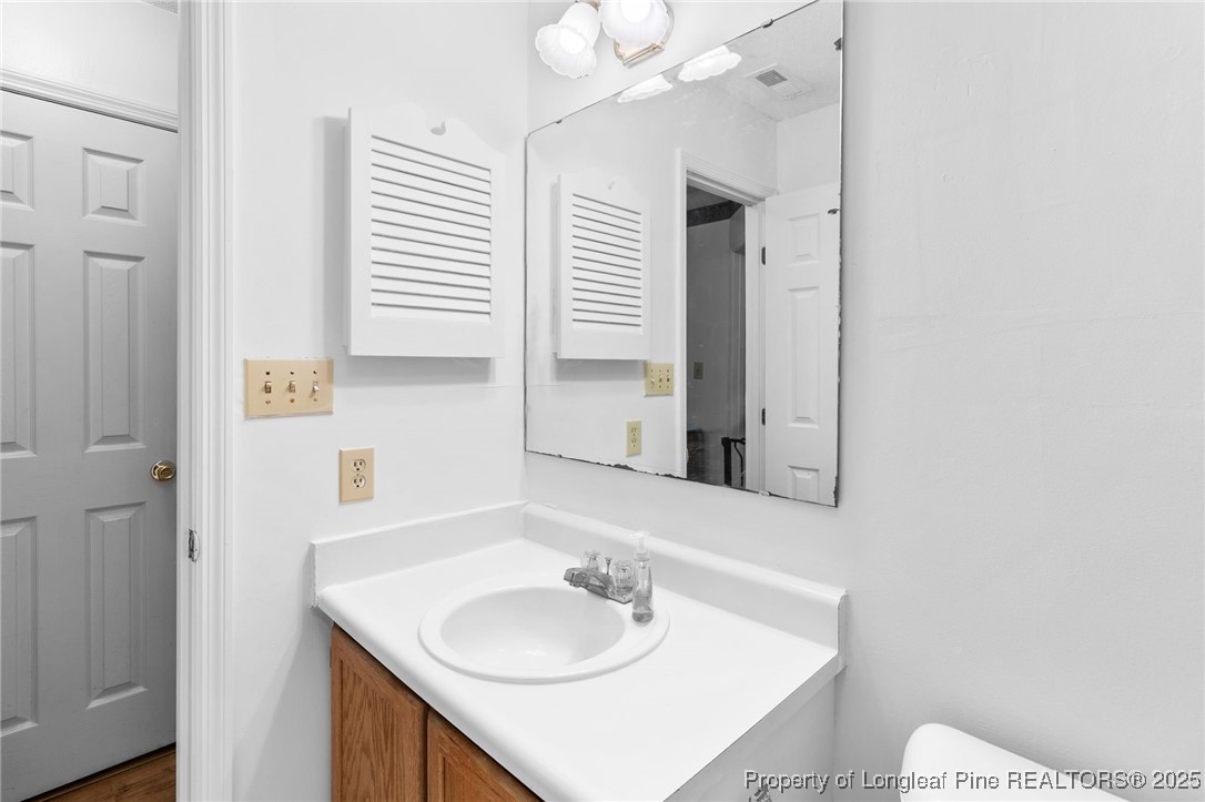 1132 Hoke Loop Road Fayetteville, NC 28314 - Photo 24 of 29 a bathroom with a sink and a mirror