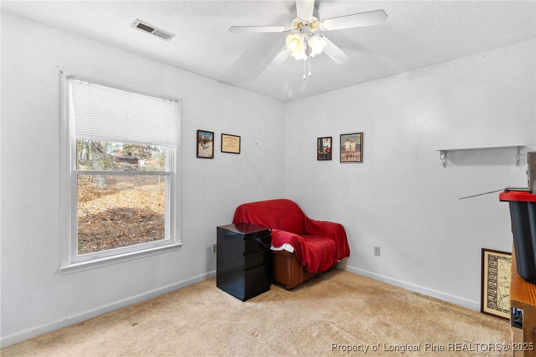1132 Hoke Loop Road Fayetteville, NC 28314 - Photo 25 of 29 a bedroom with a bed and a chandelier