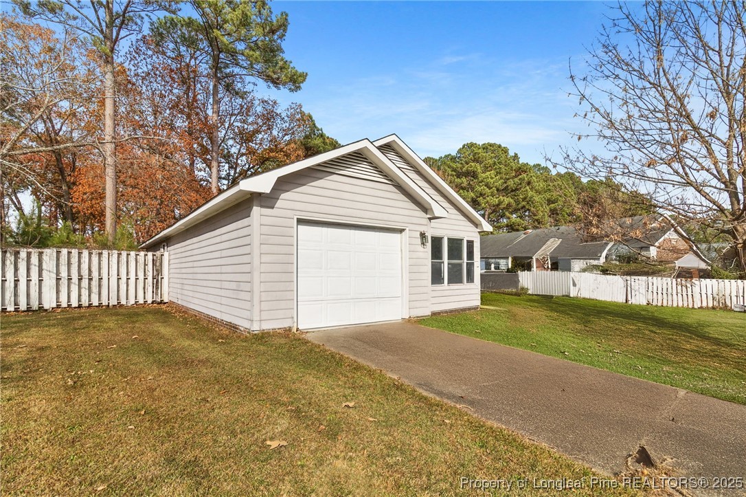 1132 Hoke Loop Road Fayetteville, NC 28314 - Photo 6 of 29 a view of a house with a yard and garage