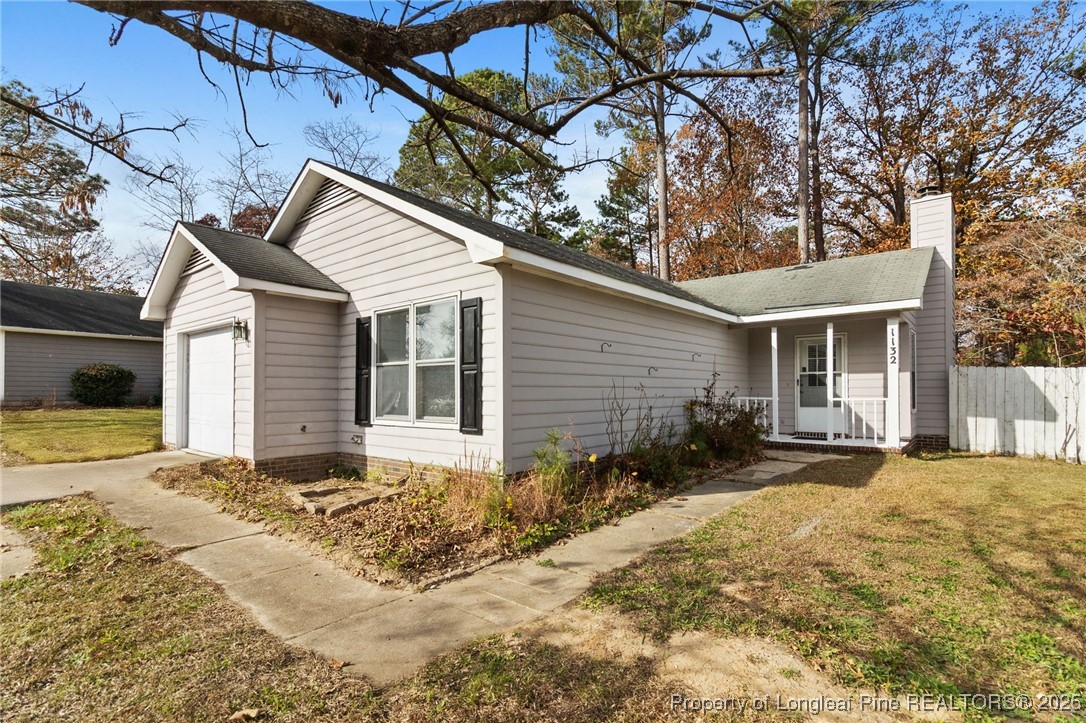 1132 Hoke Loop Road Fayetteville, NC 28314 - Photo 7 of 29 a front view of a house with a yard outdoor seating and pathway