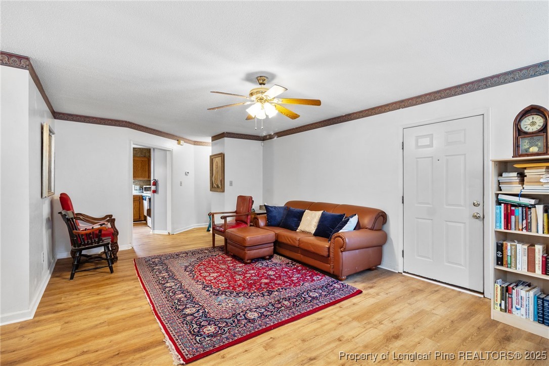 1132 Hoke Loop Road Fayetteville, NC 28314 - Photo 9 of 29 a living room with furniture and a book shelf