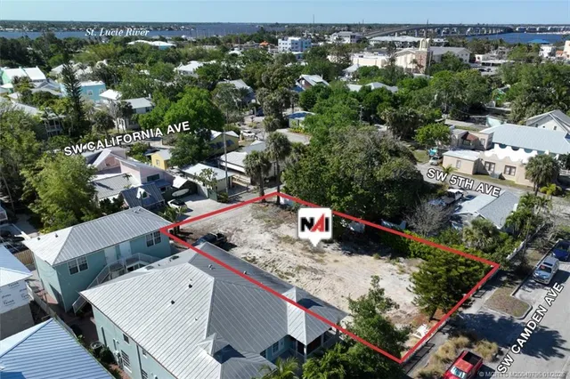 an aerial view of a house with a yard basket ball court and outdoor seating