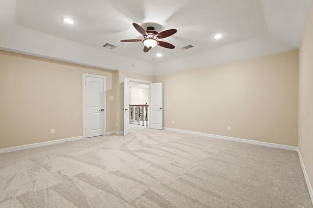 a view of an empty room with a ceiling fan