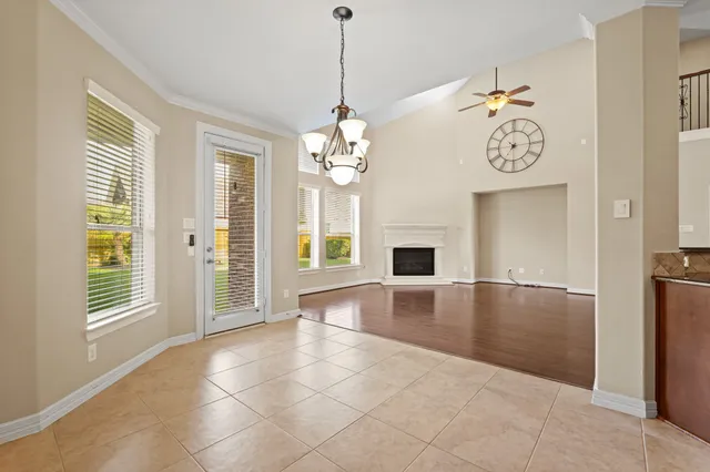 a view of an room with wooden floor and a large window