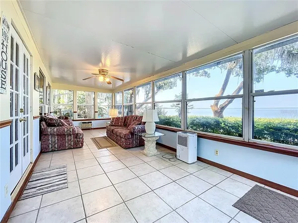 a kitchen with stainless steel appliances a refrigerator a sink and white cabinets